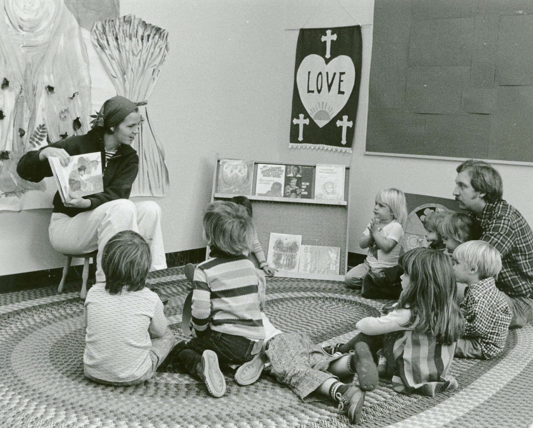 Children and instructor and possibly parent during story time in a church child care center.