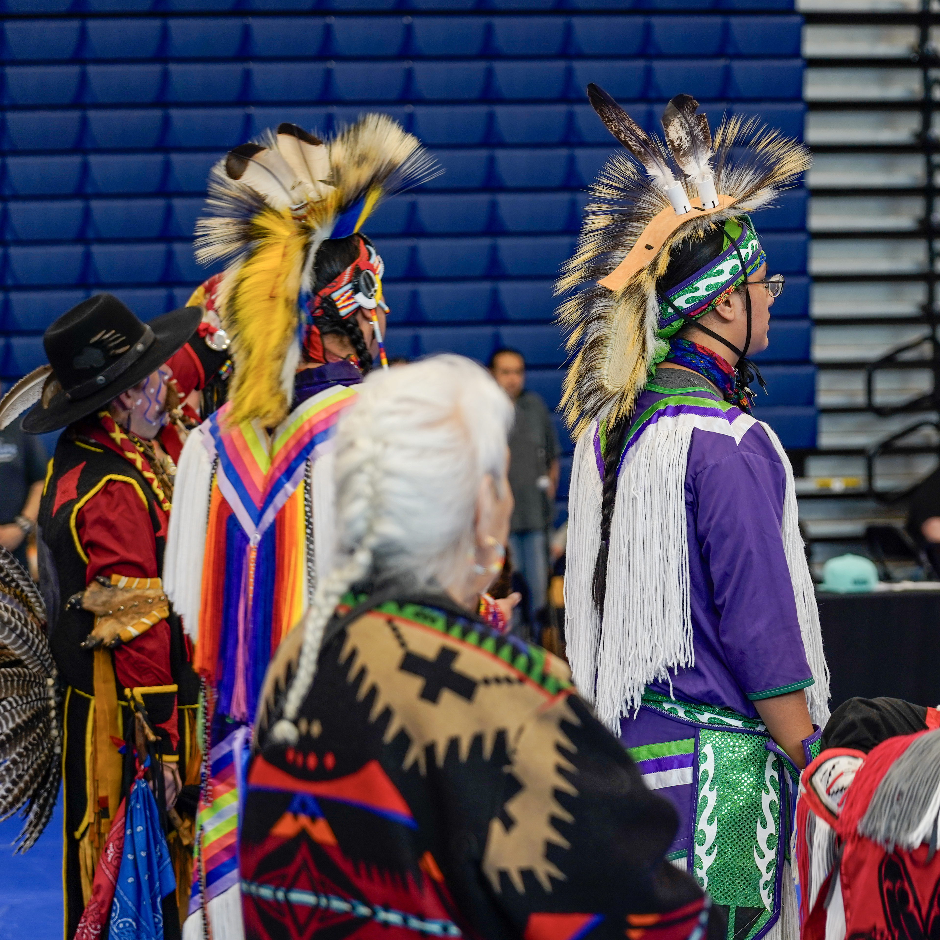 Three pow wow participants in regalia