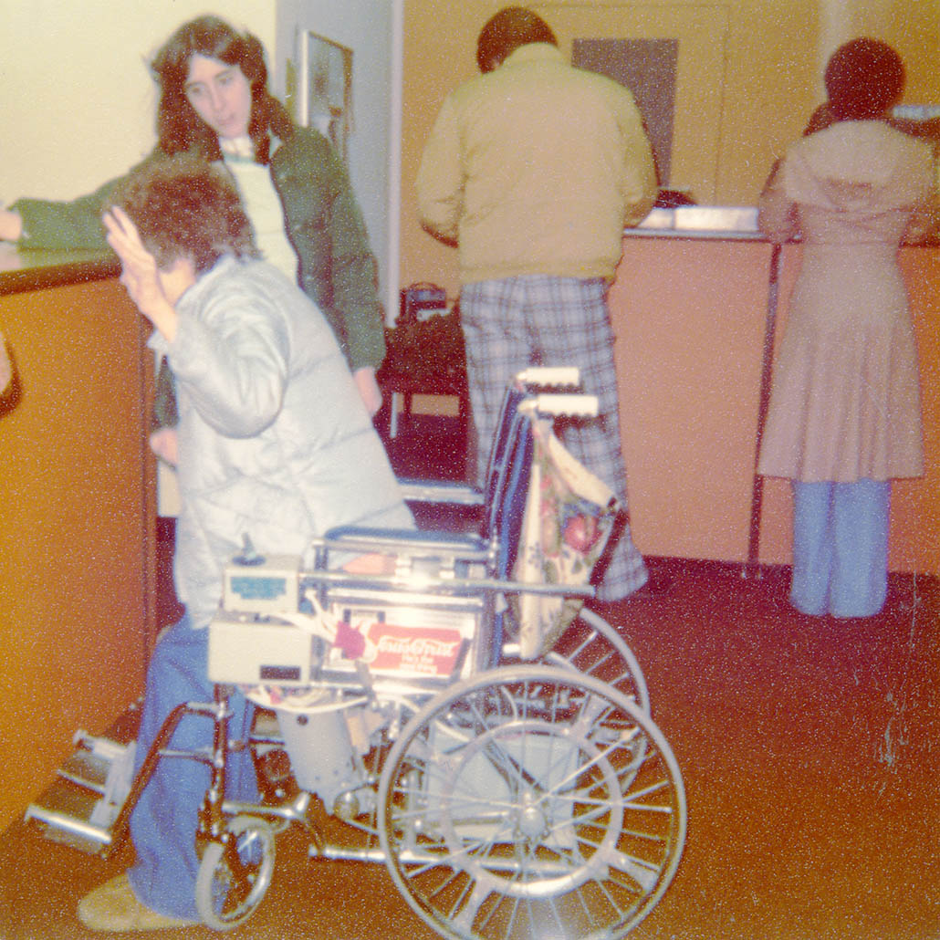 Person in wheelchair with person standing next to them
