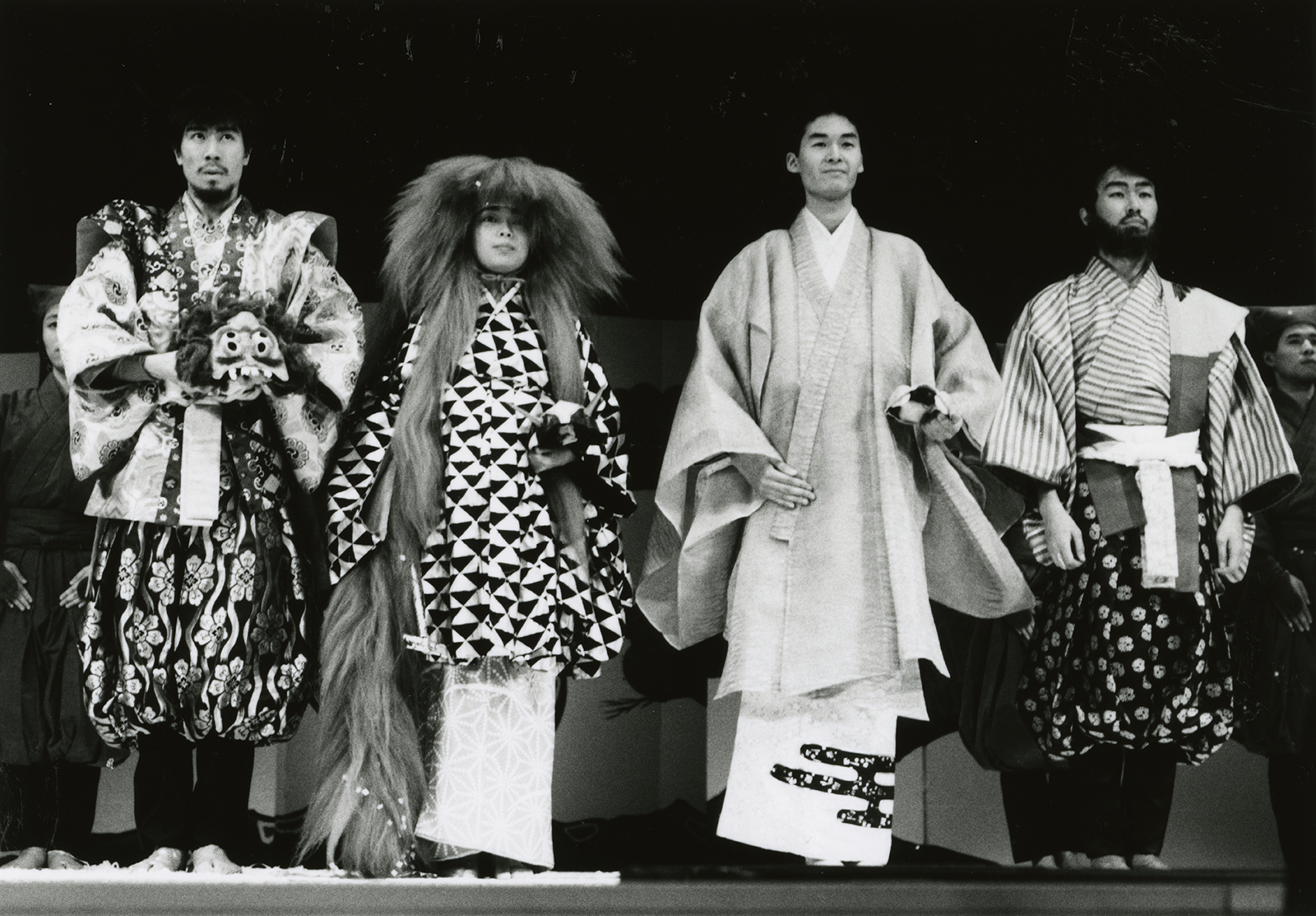Four performers in costume standing