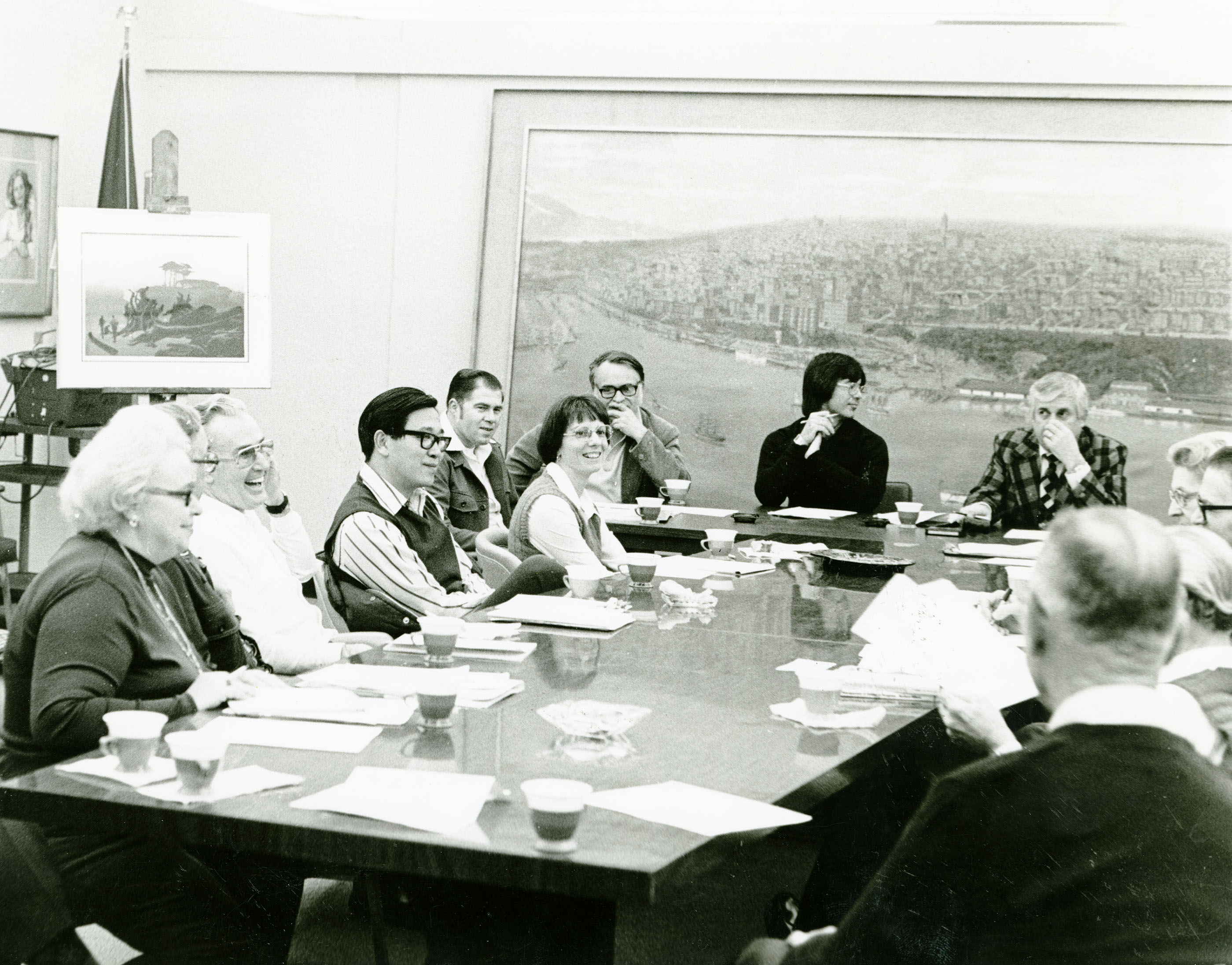 Group of people seated around meeting table