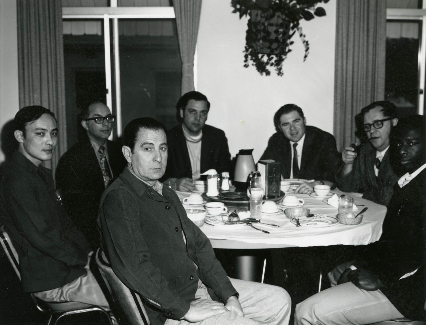 TCC administrators with McNeil inmates and administrations, seated around a dining table