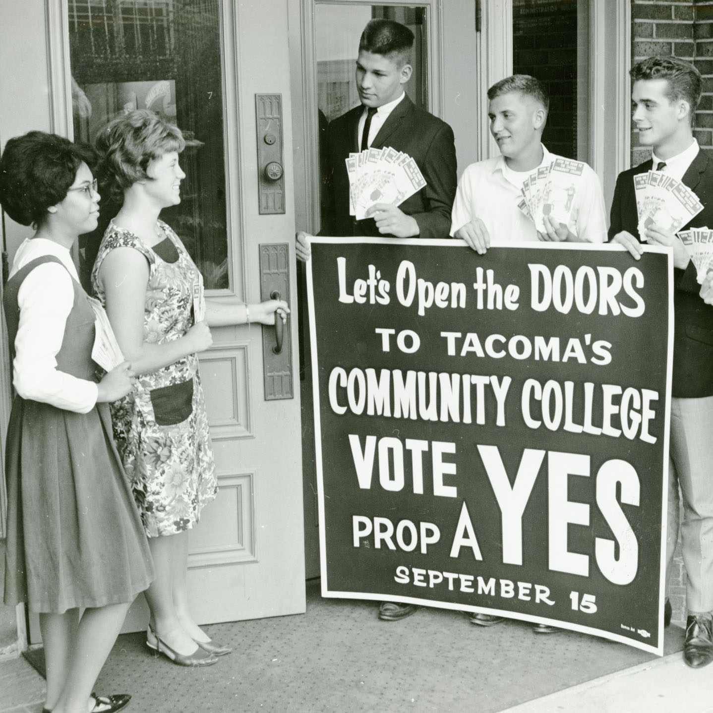 Students with sign promoting the bond measure to fund community colleges