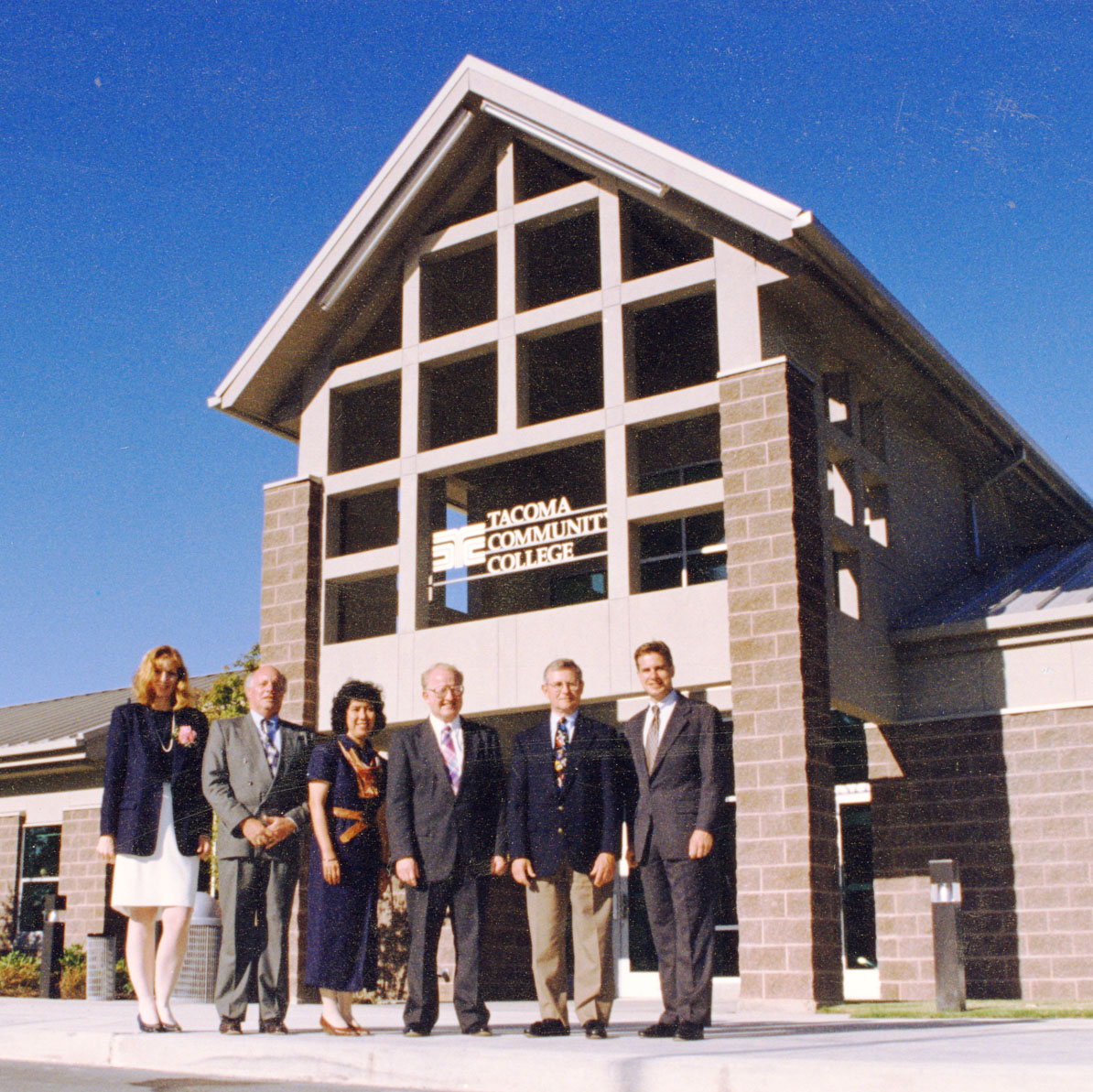 Six people standing in front of the new Gig Harbor campus building